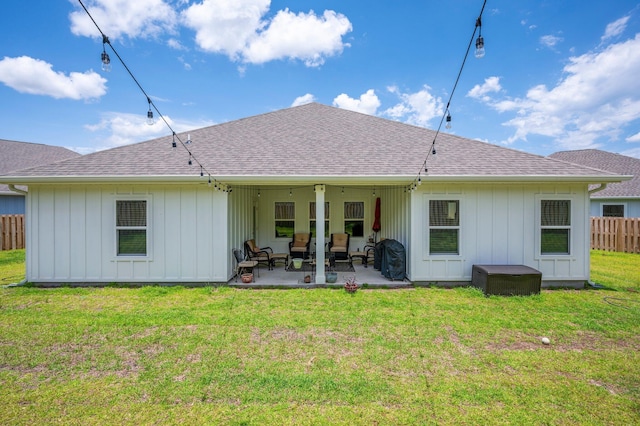 125 Hobson Ave, Crestview, FL 32539 - back of property with a patio area, roof with shingles, board and batten siding, and outdoor lounge area