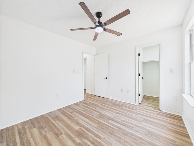 175 Villacrest Dr, Crestview, FL 32536 - unfurnished bedroom featuring light wood-style floors, baseboards, a spacious closet, and a ceiling fan