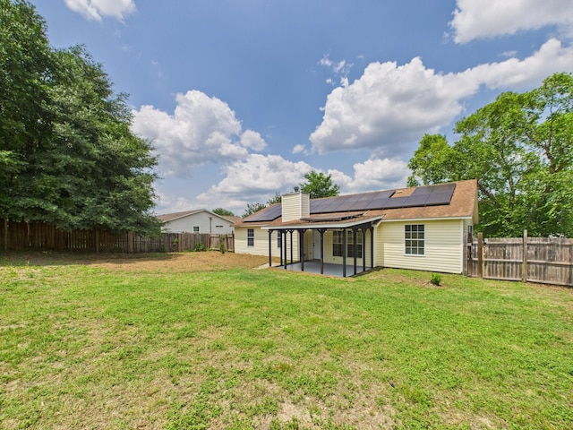 175 Villacrest Dr, Crestview, FL 32536 - back of house featuring solar panels, a patio, a chimney, and a sunroom