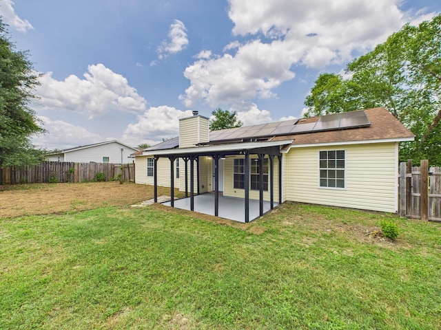175 Villacrest Dr, Crestview, FL 32536 - back of property featuring a patio, solar panels, and a chimney