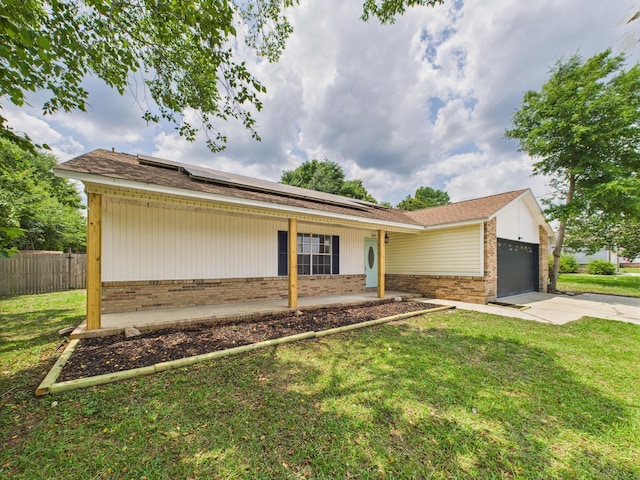175 Villacrest Dr, Crestview, FL 32536 - ranch-style house featuring brick siding, an attached garage, roof mounted solar panels, and driveway