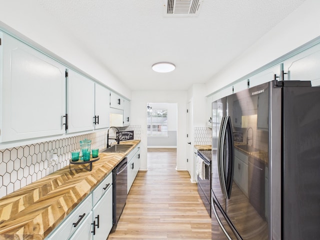 175 Villacrest Dr, Crestview, FL 32536 - kitchen featuring freestanding refrigerator, dishwasher, range with electric cooktop, backsplash, and light wood-style floors
