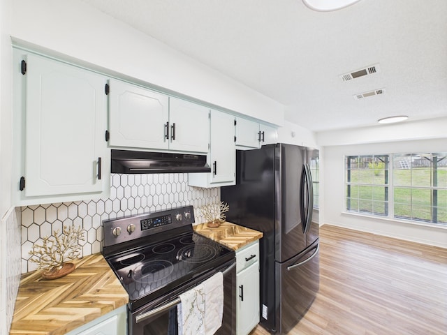 175 Villacrest Dr, Crestview, FL 32536 - kitchen with electric stove, under cabinet range hood, freestanding refrigerator, decorative backsplash, and light countertops