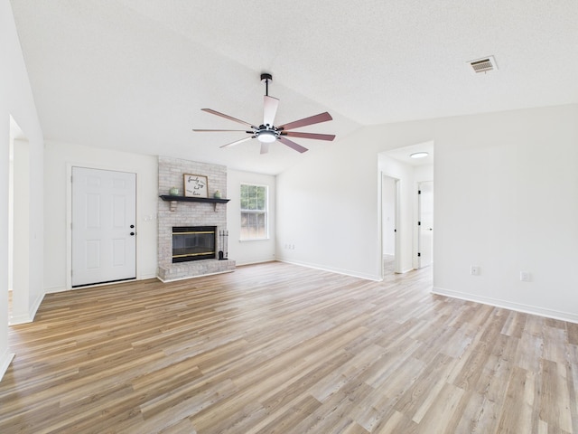 175 Villacrest Dr, Crestview, FL 32536 - unfurnished living room with ceiling fan, light wood finished floors, vaulted ceiling, a brick fireplace, and baseboards