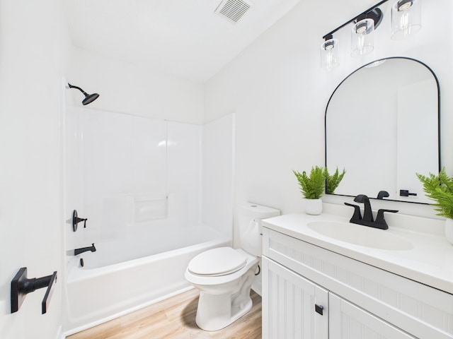 175 Villacrest Dr, Crestview, FL 32536 - full bath with toilet, vanity, wood finished floors, and washtub / shower combination