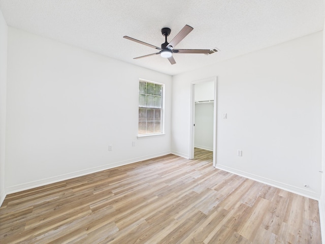 175 Villacrest Dr, Crestview, FL 32536 - unfurnished bedroom with light wood-style flooring, baseboards, a ceiling fan, a closet, and a spacious closet