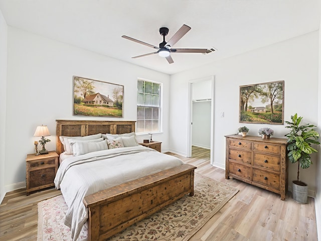 175 Villacrest Dr, Crestview, FL 32536 - bedroom with light wood-type flooring, baseboards, a walk in closet, and a ceiling fan