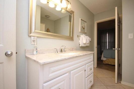 2830 Scenic Gulf Dr Unit 127, Miramar Beach, FL 32550 - bathroom with vanity, tile patterned floors, and baseboards