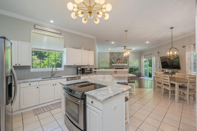 4680 Lovegrass Ln, Crestview, FL 32539 - kitchen with appliances with stainless steel finishes, a chandelier, light tile patterned floors, a kitchen island, and ornamental molding
