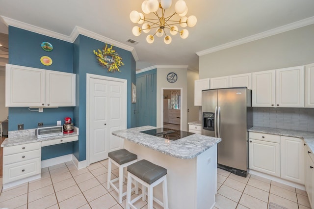 4680 Lovegrass Ln, Crestview, FL 32539 - kitchen with stainless steel fridge with ice dispenser, black electric stovetop, light tile patterned floors, ornamental molding, and backsplash