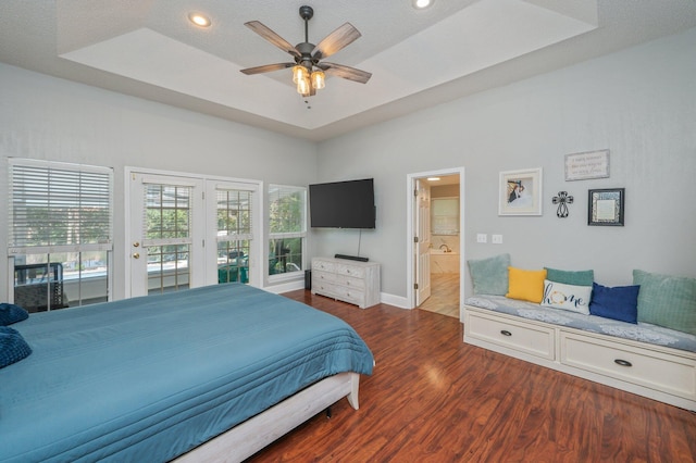 4680 Lovegrass Ln, Crestview, FL 32539 - bedroom with a tray ceiling, wood finished floors, access to outside, recessed lighting, and ensuite bath