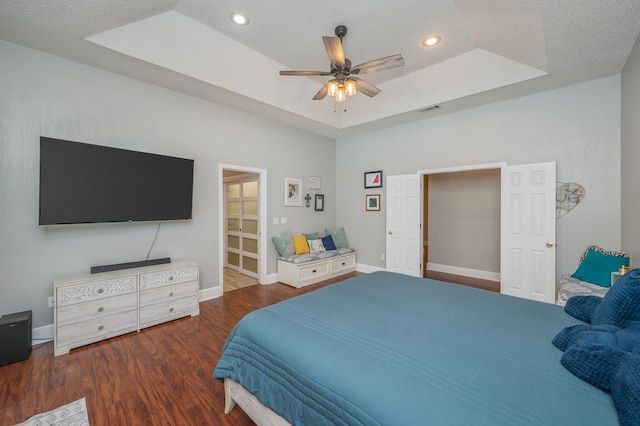 4680 Lovegrass Ln, Crestview, FL 32539 - bedroom featuring wood finished floors, a tray ceiling, a textured ceiling, ceiling fan, and recessed lighting