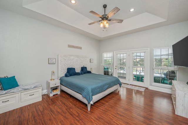 4680 Lovegrass Ln, Crestview, FL 32539 - bedroom featuring dark wood-style floors, access to outside, a tray ceiling, multiple windows, and recessed lighting