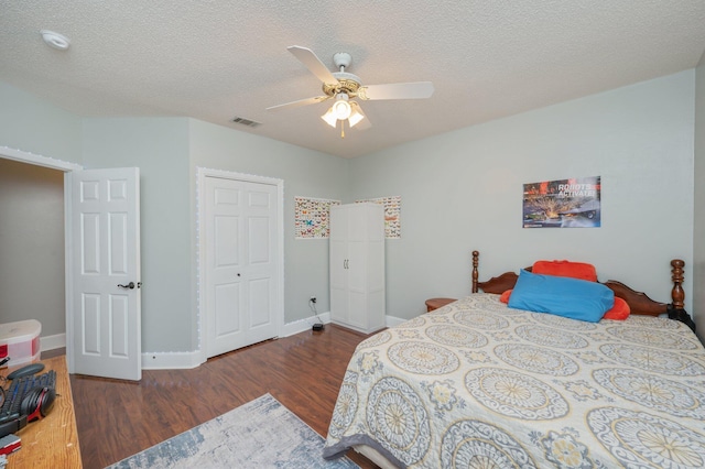 4680 Lovegrass Ln, Crestview, FL 32539 - bedroom featuring wood finished floors, a ceiling fan, a textured ceiling, and a closet
