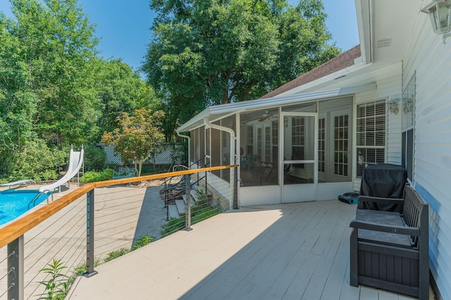 4680 Lovegrass Ln, Crestview, FL 32539 - wooden terrace featuring a sunroom, an outdoor pool, and area for grilling
