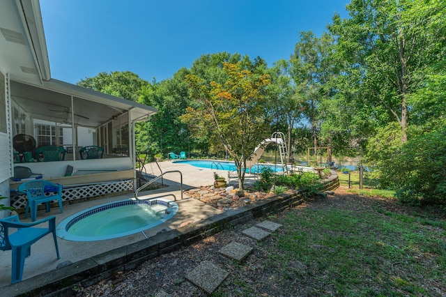 4680 Lovegrass Ln, Crestview, FL 32539 - outdoor pool featuring a water slide, a sunroom, an in-ground hot tub, ceiling fan, and a patio