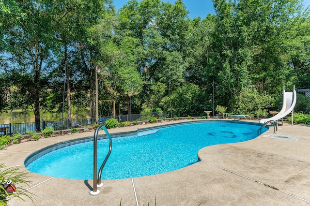 4680 Lovegrass Ln, Crestview, FL 32539 - view of pool featuring a patio, a water slide, a diving board, and view of scattered trees