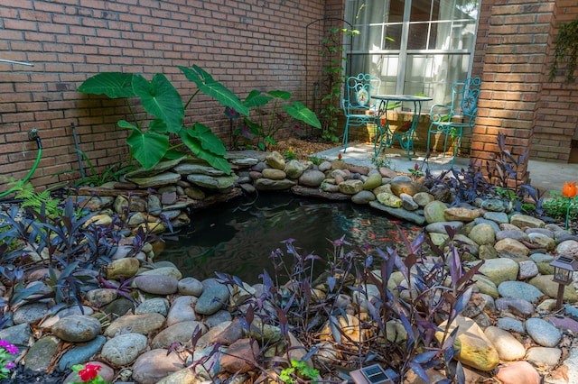 4680 Lovegrass Ln, Crestview, FL 32539 - exterior view of brick siding and a small pond