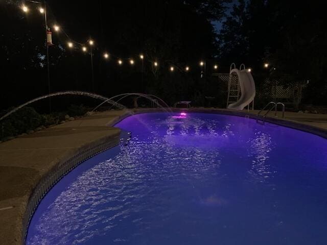 4680 Lovegrass Ln, Crestview, FL 32539 - pool at night with a water slide and an outdoor pool