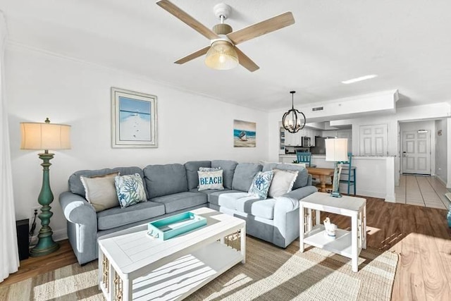 14701 Front Beach Rd Unit 1331, Panama City Beach, FL 32413 - living area with ceiling fan, a chandelier, light wood-style flooring, ornamental molding, and baseboards