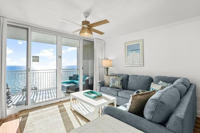 14701 Front Beach Rd Unit 1331, Panama City Beach, FL 32413 - living room featuring a ceiling fan, wood finished floors, a water view, and ornamental molding