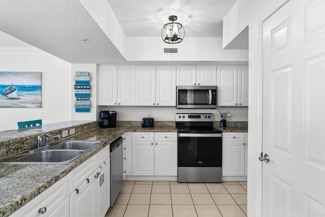 14701 Front Beach Rd Unit 1331, Panama City Beach, FL 32413 - kitchen with stainless steel appliances, a sink, light tile patterned floors, and white cabinets