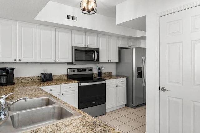 14701 Front Beach Rd Unit 1331, Panama City Beach, FL 32413 - kitchen with stainless steel appliances, a sink, white cabinets, light tile patterned flooring, and light stone countertops