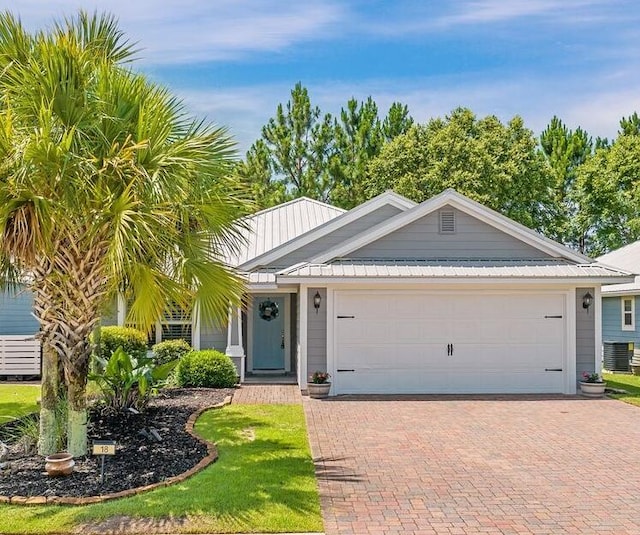 18 Bald Eagle Dr, Santa Rosa Beach, FL 32459 - ranch-style home with an attached garage, decorative driveway, and a metal roof