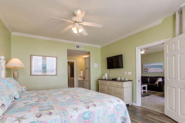 8499 Gulf Blvd Unit 303, Navarre, FL 32566 - bedroom featuring wood finished floors, crown molding, a ceiling fan, a textured ceiling, and connected bathroom
