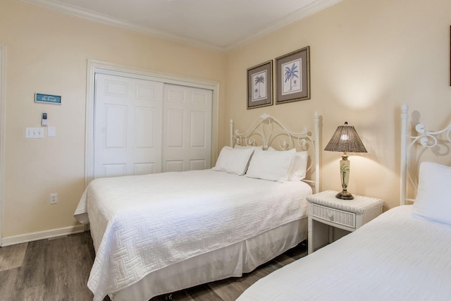 8499 Gulf Blvd Unit 303, Navarre, FL 32566 - bedroom with a closet, dark wood-type flooring, and crown molding