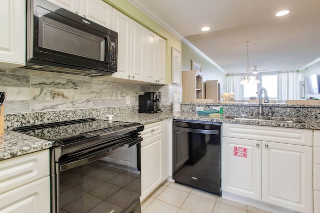 8499 Gulf Blvd Unit 303, Navarre, FL 32566 - kitchen featuring black appliances, crown molding, tasteful backsplash, light stone countertops, and white cabinetry