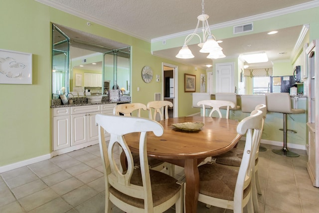 8499 Gulf Blvd Unit 303, Navarre, FL 32566 - dining area with crown molding, light tile patterned floors, and a textured ceiling