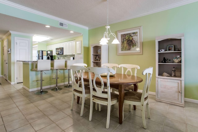 8499 Gulf Blvd Unit 303, Navarre, FL 32566 - dining space featuring ornamental molding, a chandelier, light tile patterned floors, and a textured ceiling