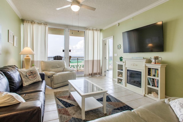 8499 Gulf Blvd Unit 303, Navarre, FL 32566 - living area featuring a textured ceiling, ceiling fan, crown molding, light tile patterned floors, and a glass covered fireplace
