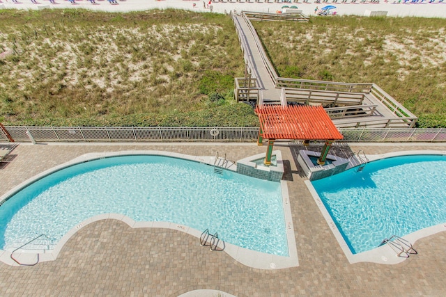 8499 Gulf Blvd Unit 303, Navarre, FL 32566 - community pool featuring a patio area