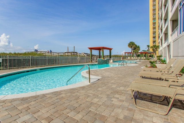 8499 Gulf Blvd Unit 303, Navarre, FL 32566 - community pool featuring a patio and a pergola