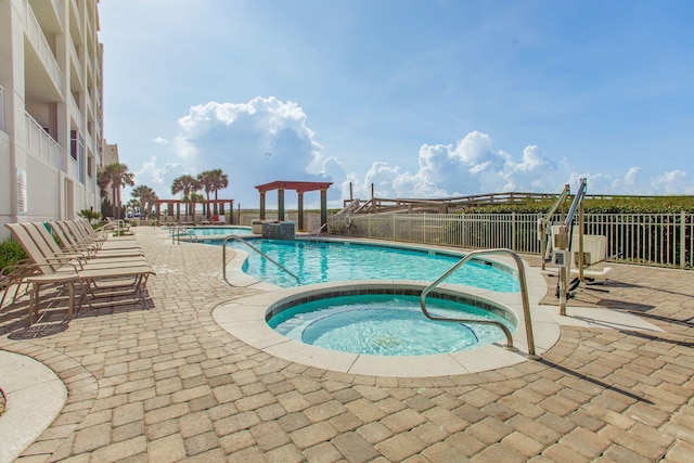 8499 Gulf Blvd Unit 303, Navarre, FL 32566 - community pool with a community hot tub and a patio