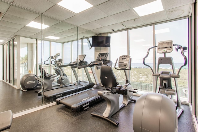 8499 Gulf Blvd Unit 303, Navarre, FL 32566 - workout area featuring a wall of windows, healthy amount of natural light, and a drop ceiling