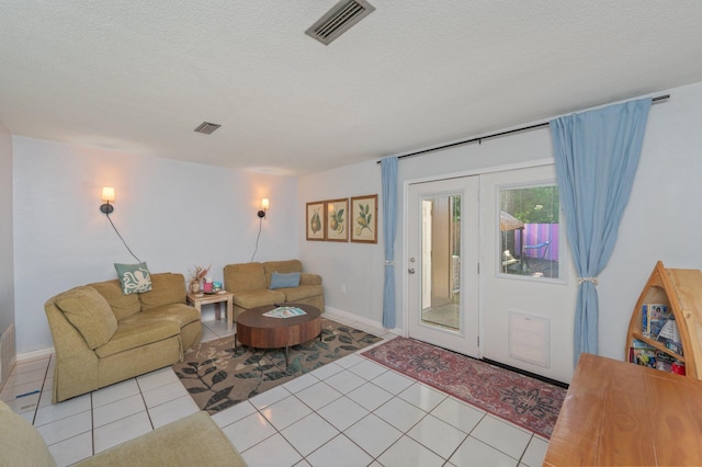 208 3rd St Unit J, Fort Walton Beach, FL 32548 - living area featuring a textured ceiling, light tile patterned flooring, and baseboards