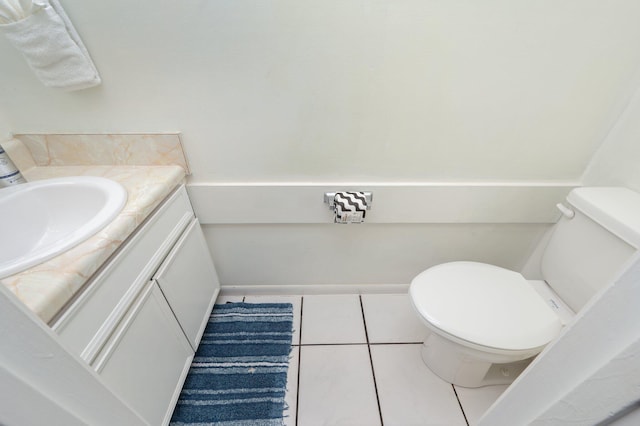208 3rd St Unit J, Fort Walton Beach, FL 32548 - bathroom featuring vanity, toilet, tile patterned floors, and baseboards