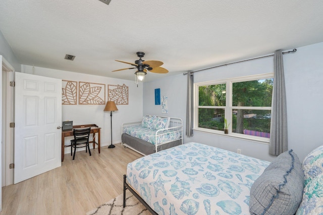 208 3rd St Unit J, Fort Walton Beach, FL 32548 - bedroom featuring light wood finished floors, a ceiling fan, and a textured ceiling
