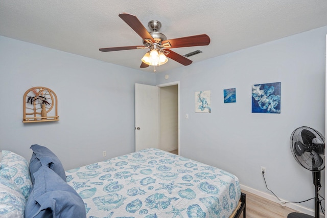 208 3rd St Unit J, Fort Walton Beach, FL 32548 - bedroom with light wood finished floors, ceiling fan, and baseboards
