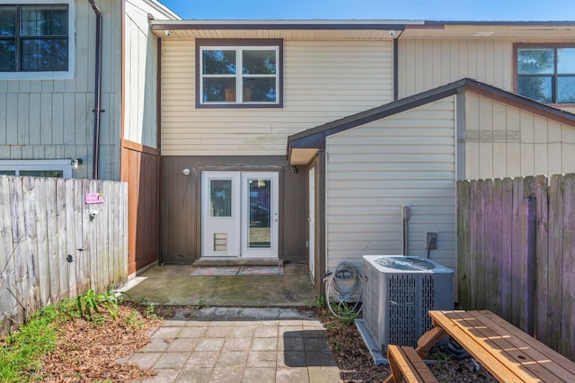 208 3rd St Unit J, Fort Walton Beach, FL 32548 - rear view of house with central AC unit and a fenced backyard