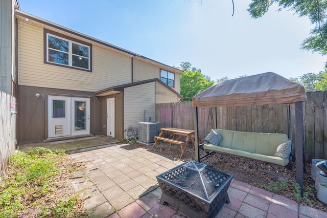 208 3rd St Unit J, Fort Walton Beach, FL 32548 - back of house with central AC unit, a patio, and a fenced backyard