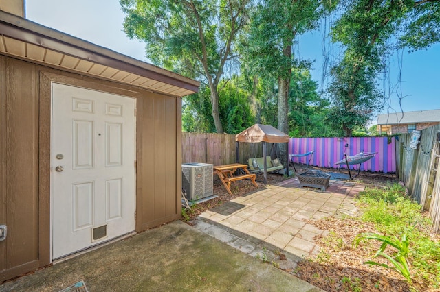 208 3rd St Unit J, Fort Walton Beach, FL 32548 - fenced backyard with central AC unit, a patio area, and an outdoor structure