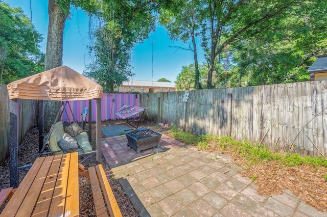 208 3rd St Unit J, Fort Walton Beach, FL 32548 - fenced backyard featuring a patio and an outdoor fire pit