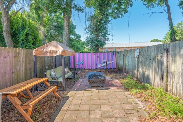 208 3rd St Unit J, Fort Walton Beach, FL 32548 - fenced backyard with an outdoor fire pit and a patio