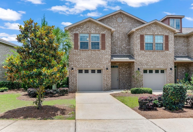 2131 Wilsons Plover Cir, Navarre, FL 32566 - view of front of house featuring a garage, concrete driveway, and brick siding