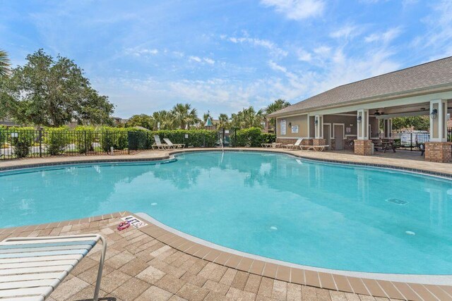 2131 Wilsons Plover Cir, Navarre, FL 32566 - community pool featuring a patio and a ceiling fan