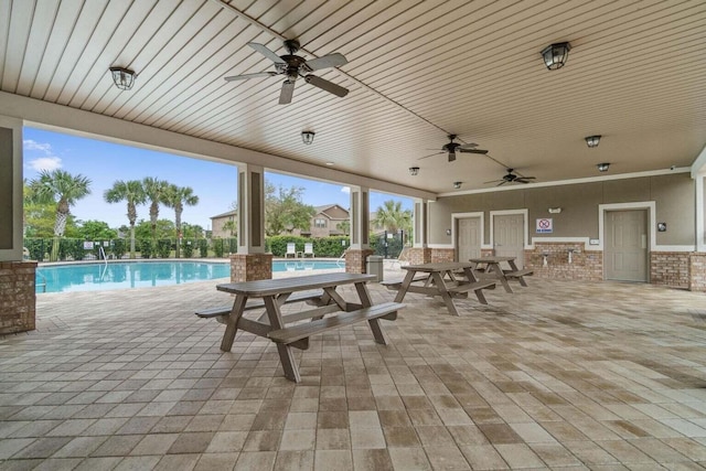 2131 Wilsons Plover Cir, Navarre, FL 32566 - view of patio featuring a ceiling fan and a community pool